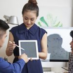 Professionals discussing regulatory compliance for a medical device manufacturer in Malaysia, implementing ISO 13485.