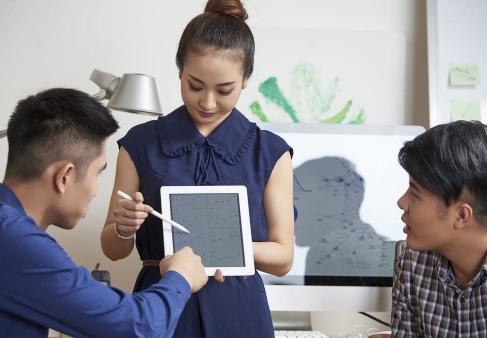 Professionals discussing regulatory compliance for a medical device manufacturer in Malaysia, implementing ISO 13485.